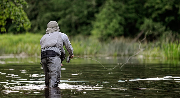 fly fishing tips - man fly fishing in a stream