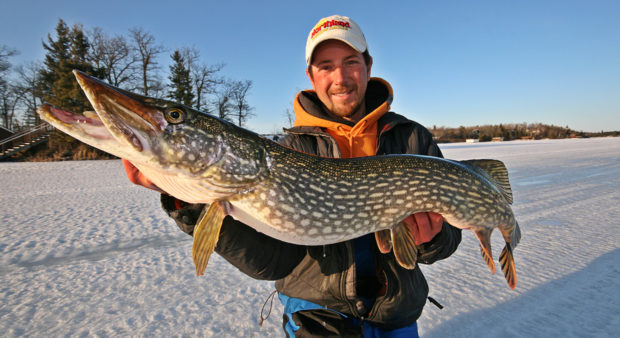 tip-up tricks - man holding a large pike