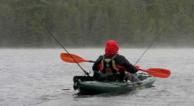 kayak trolling - man fishing in a kayak