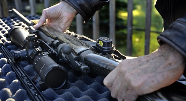 man taking a gun from a case