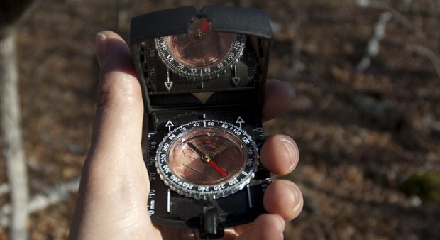 missing - hand holding a compass