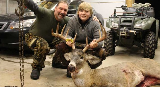 man with his son and a deer